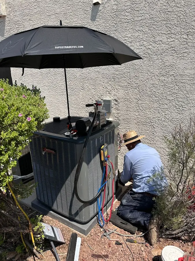 HVAC technician performing outdoor AC maintenance in Chester